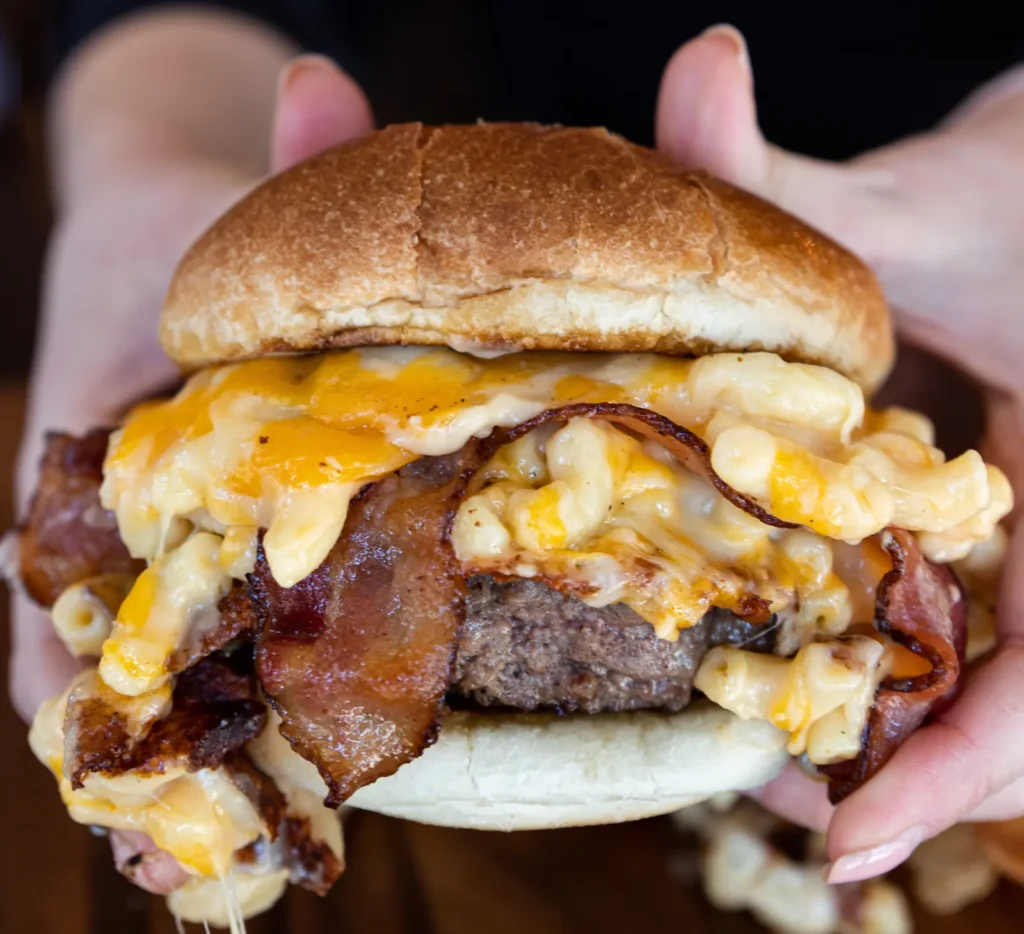 a close photo of Boston Burger Company's Mac Attack Burger, which was made with this mac and cheese recipe without milk