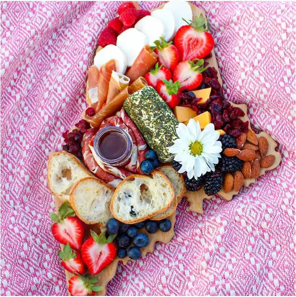 a picture from jordansplate's Instagram account, showing a triangular platter filled with colorful foods and fruits