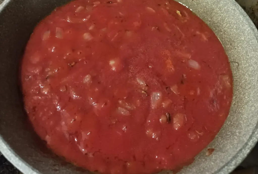 tomato sauce simmering in the saucepan