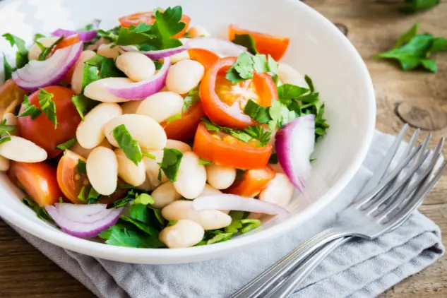a bean salad in a bowl, ready to be served as a catering side dish