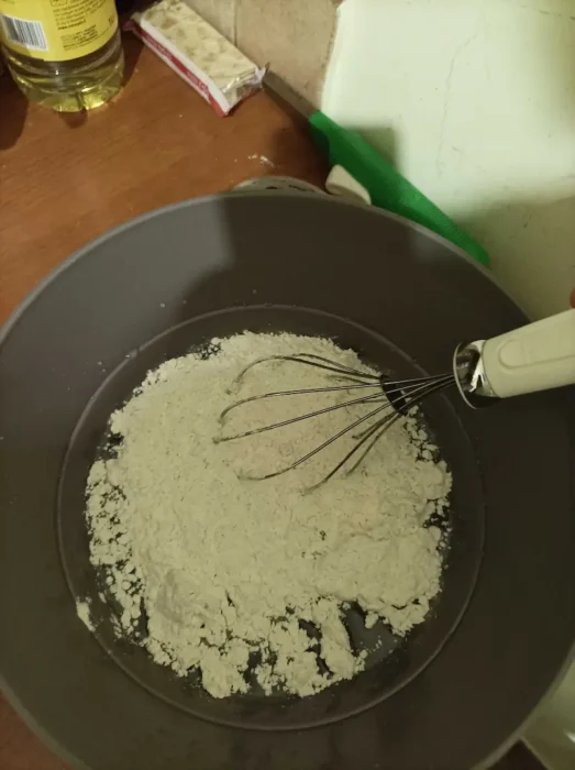 adding flour to the bowl