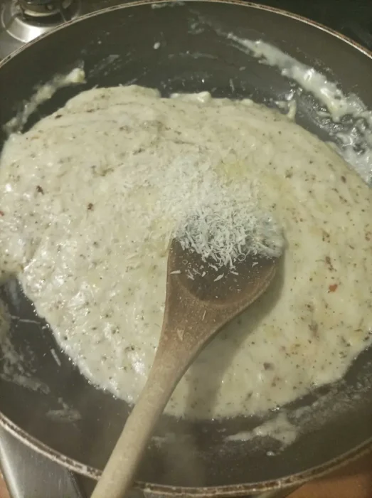 incorporating the spices and the white cheeses into a garlic pizza sauce