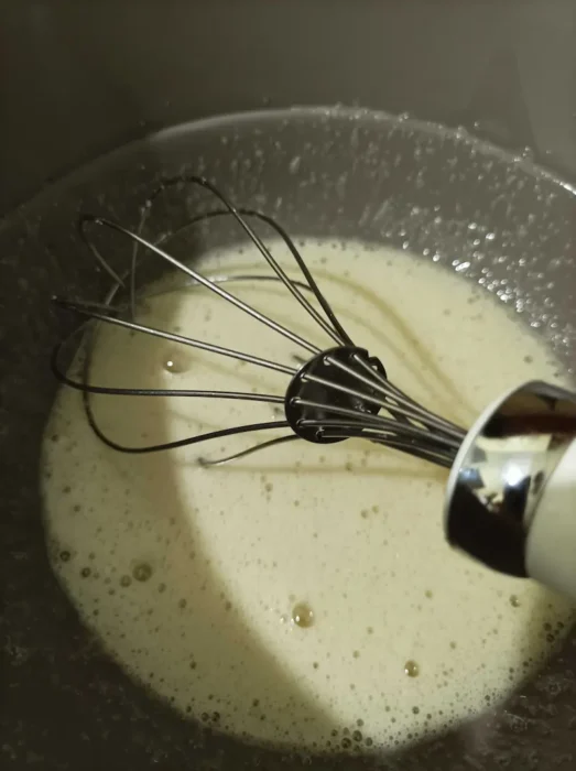 whisking eggs with sugar and seed oil