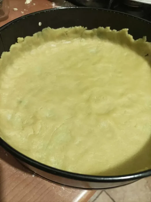 the shortcrust pastry has been flattened and spread on a springform pan