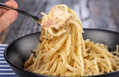 a bowl full of pasta alla carbonara
