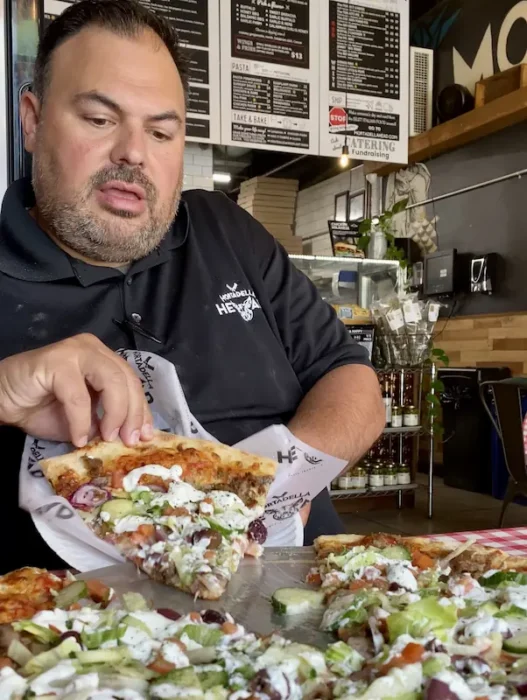 Sebby trying his own greek pizza recipe