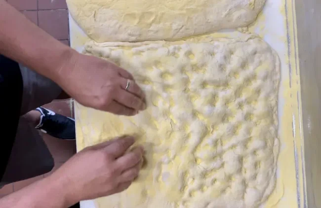 stretching the gyro pizza dough