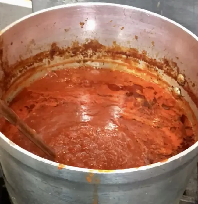 red pizza sauce simmering in a large pot