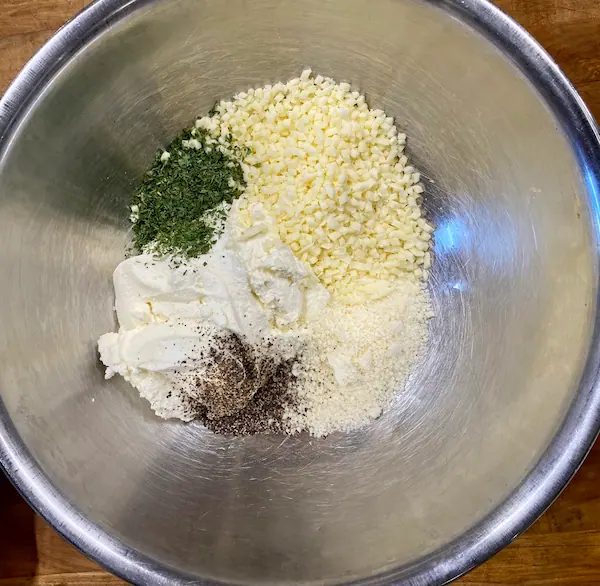 a ricotta mixture with mozzarella cheese, parmesan cheese, and seasoning