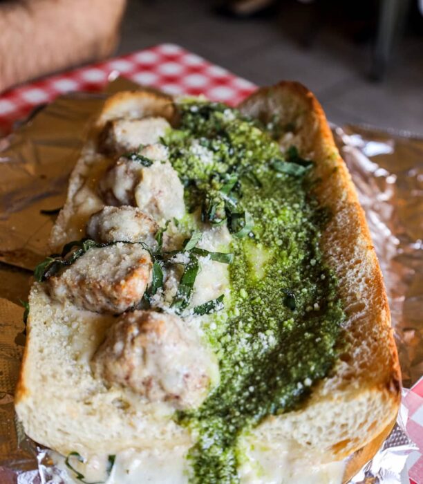 a sandwich that we made with meatballs, greens, and alfredo sauce
