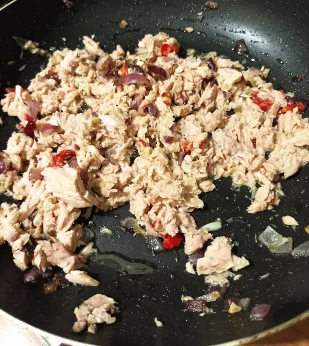 adding tuna to the saucepan