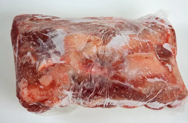 a piece of frozen pork meat