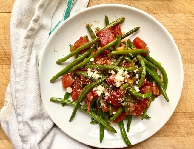 sauteed frozen green beans on a white plate