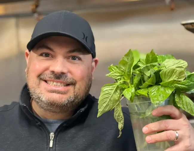 Sebby with a bunch of basil