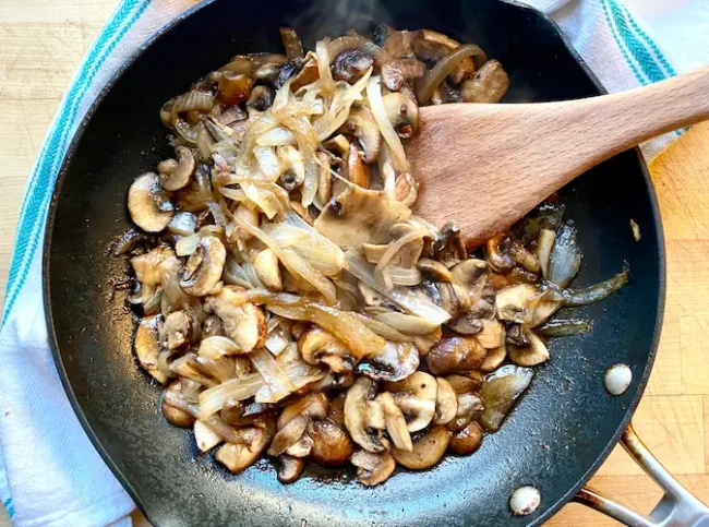 sauteed mushrooms and onions in a saucepan, ready to be used for a juicy burger