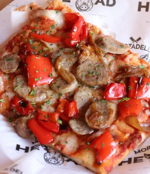 a slice of our pizza topped with Italian sausage plus sauteed peppers and onions