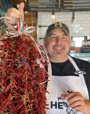 Chuck happily holding a lot of Calabrian chili peppers