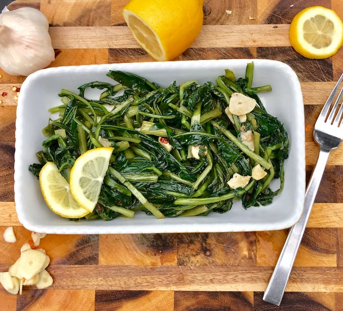 Finished dish of dandelion greens cooked with olive oil, garlic and lemon