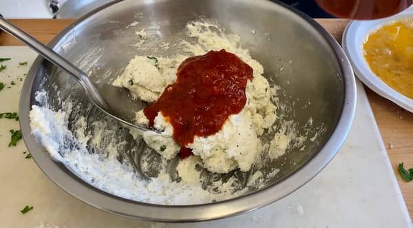adding tomato to the ricotta mixture