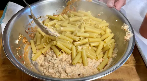 a bowl full of pasta and ricotta mixture to make baked ziti at home