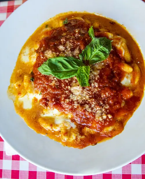 a plate of gnocchi sorrentina, a traditional Italian dish made with marinara sauce