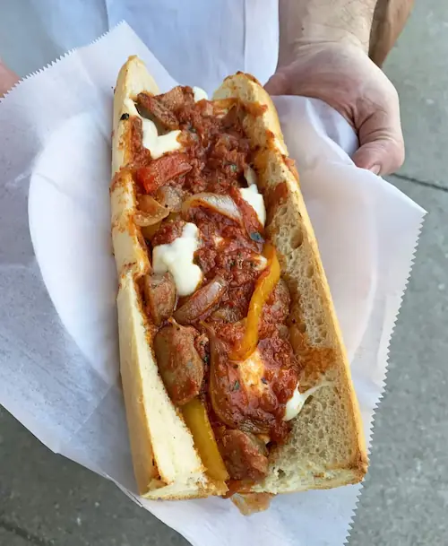 a sausage pepper and onion sub made perfect by adding marinara sauce