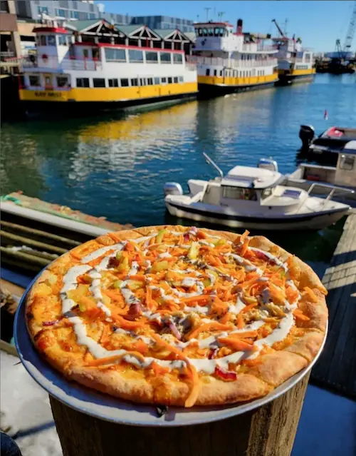 a round pizza from flatbread company portland, portland, maine