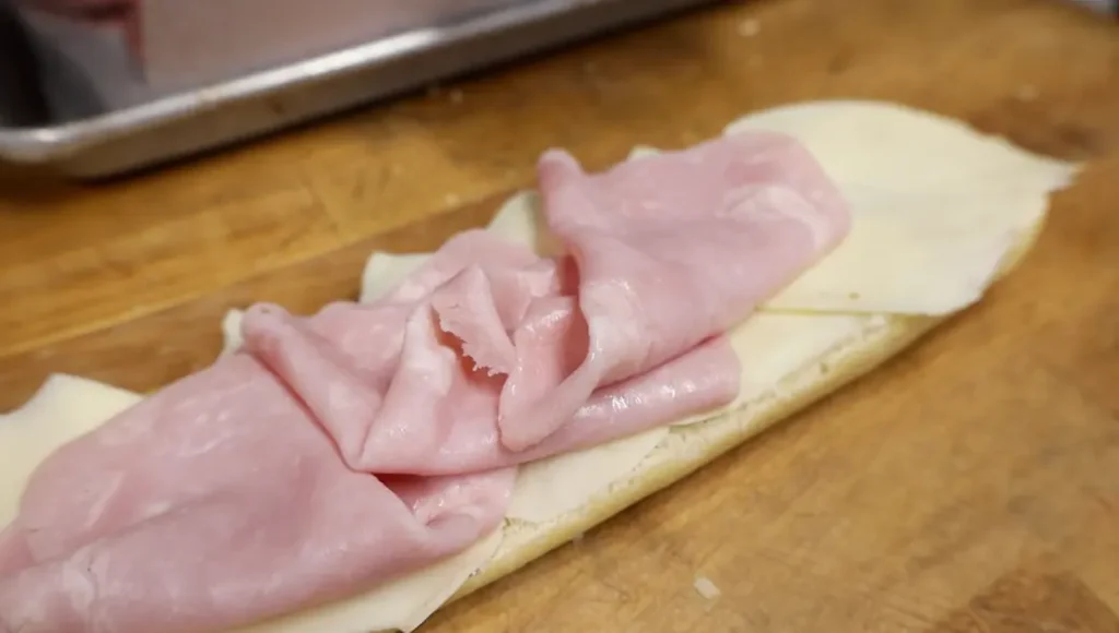 how to make an italian sub sandwich step 2: ham on provolone