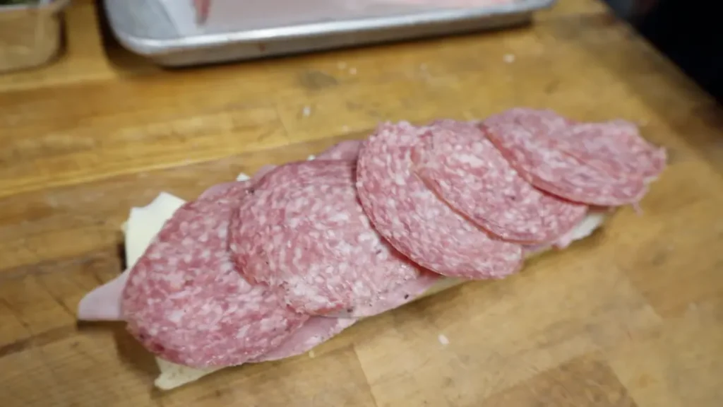 how to make an italian sub sandwich step 5: salami on capicola