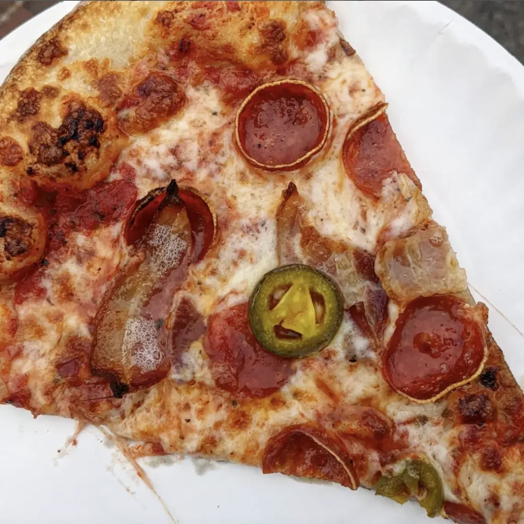 a slice of cape cod pizza made by moto pizza