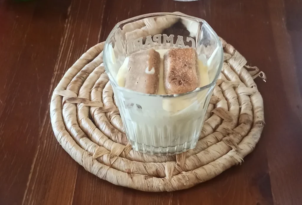 a tiramisu cup with 2 layers of savoiardi biscuits and cream