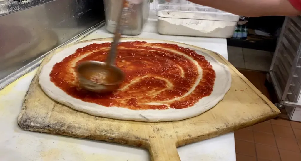 a 16 inch pizza before being put in the oven