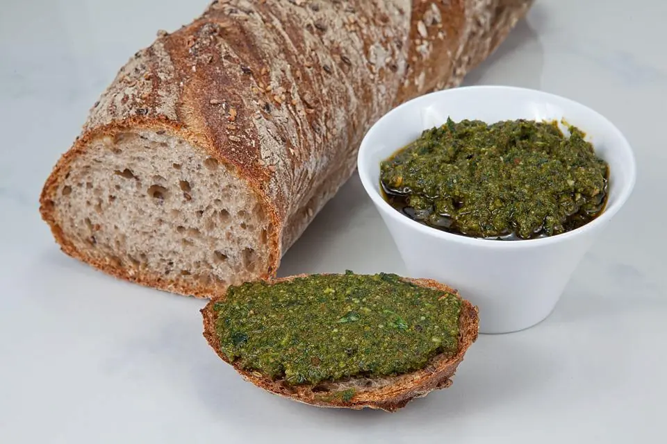 a picture of a baguette and a loaf of bread topped with pesto, which is one of my favorite side dishes for lasagna