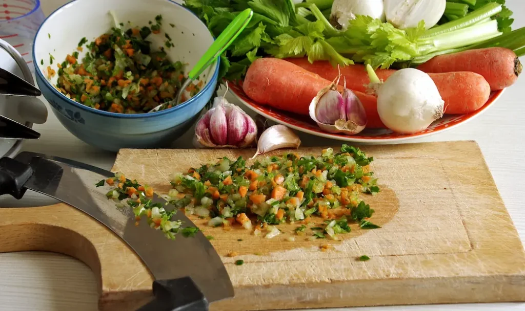 some vegetables in the process of being chopped before being used for this Italian soffritto recipe