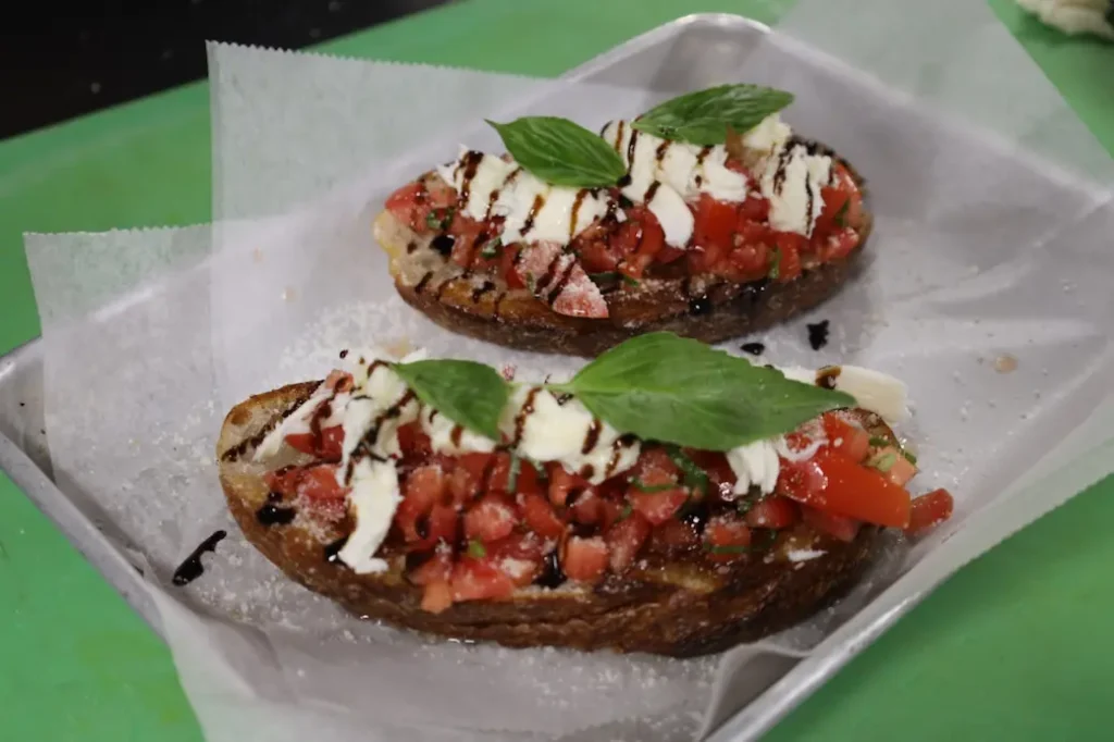 a picture of 2 finished bruschettas made with this bruschetta mozzarella recipe