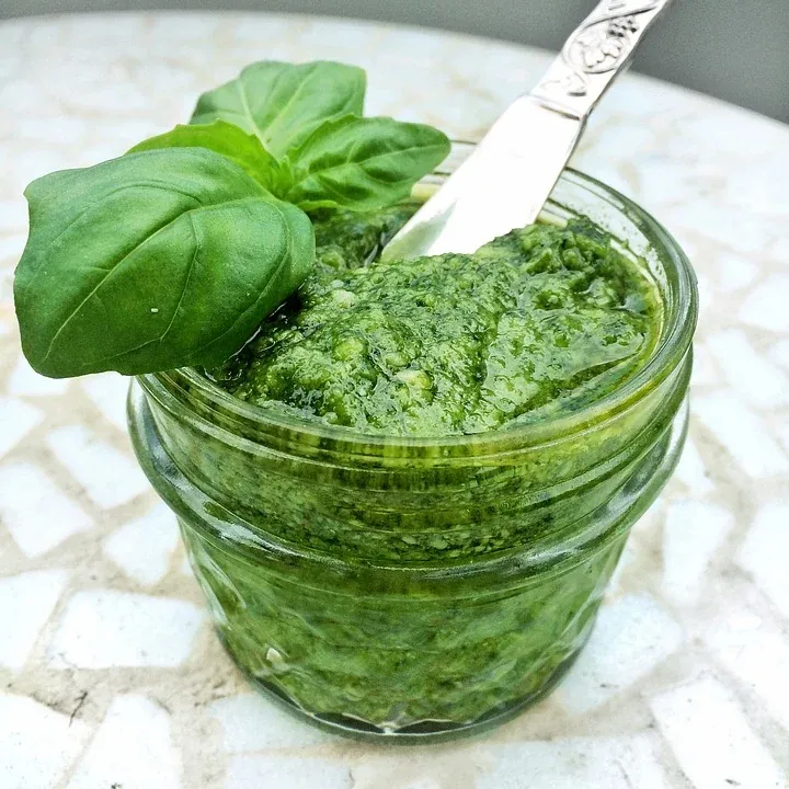 green pesto in a glass container