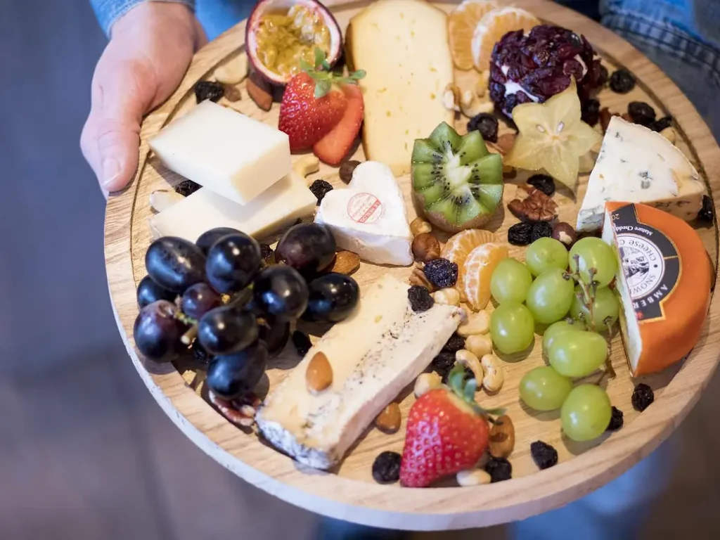 different cheese on a platter with fruit