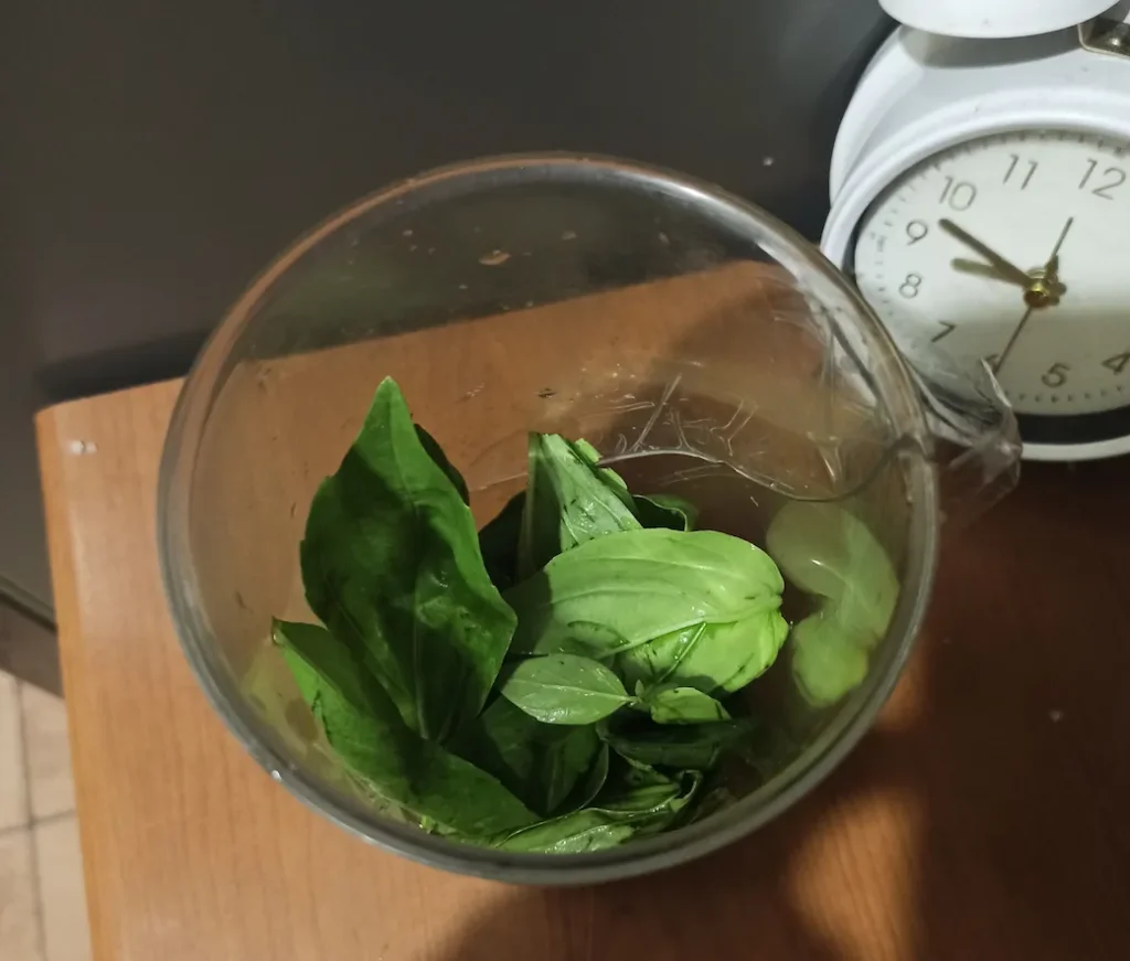 basil leaves in an immersion blender