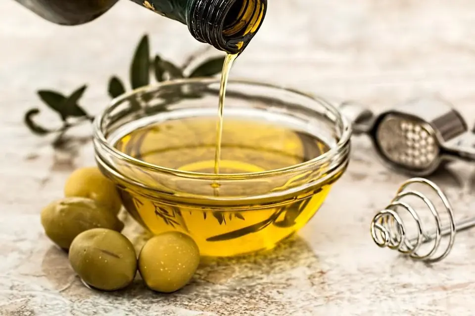 olive oil being poured in a little bowl