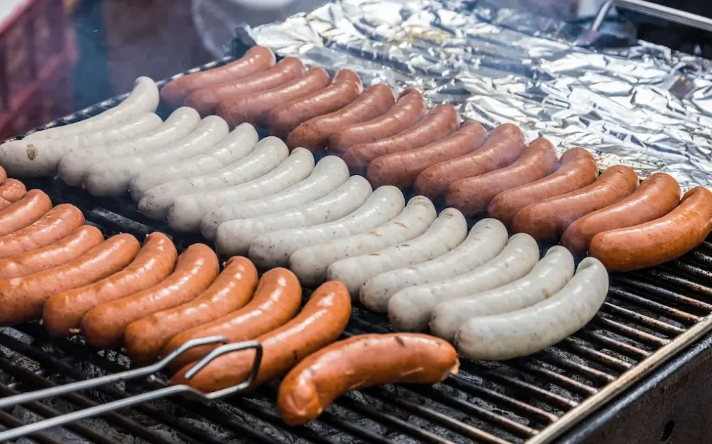 sausages and bratwursts on a grill