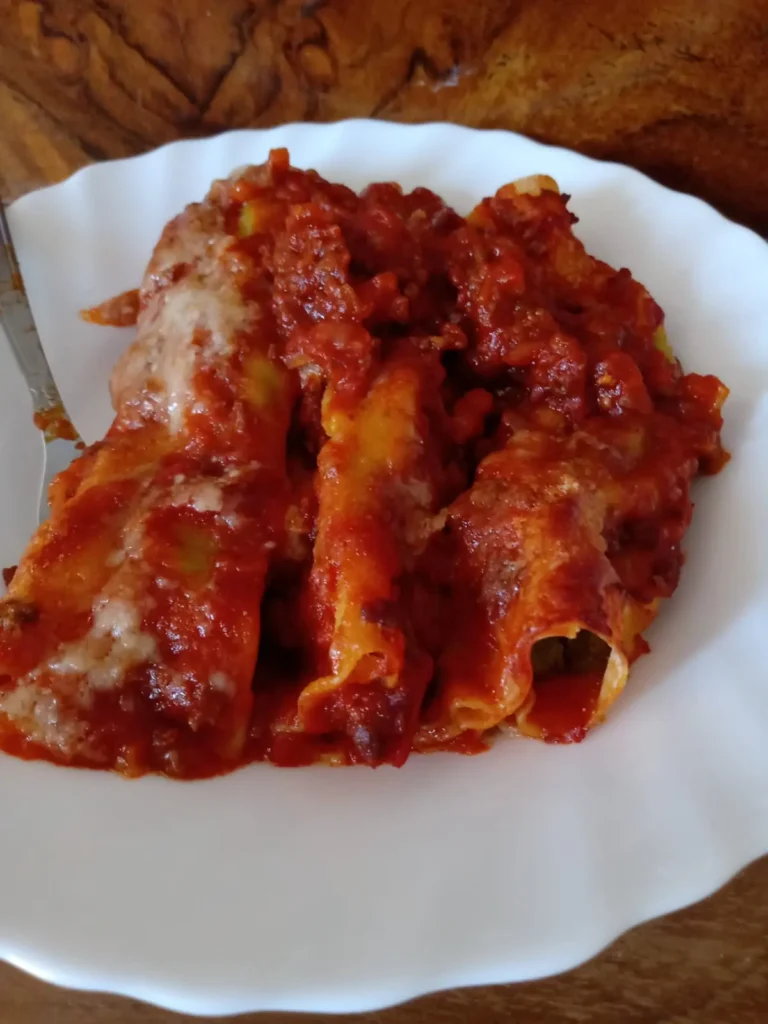 three baked cannelloni on a plate