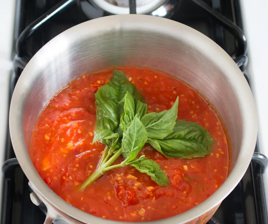 marinara sauce simmering in a pot to thicken