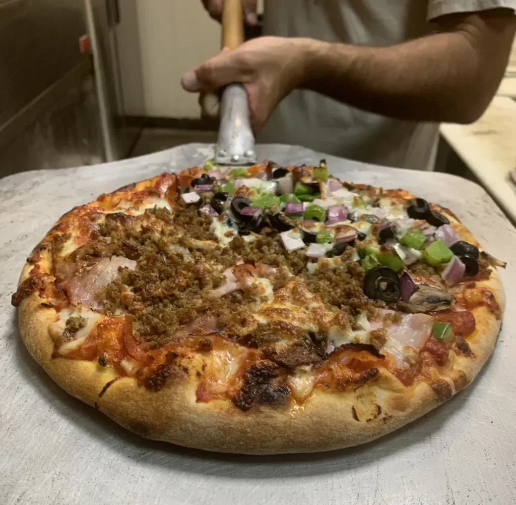 a round pie pizza from Pizza Madness, Maui Island