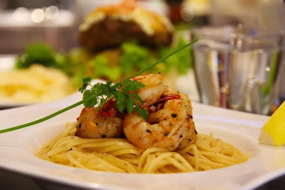 a pasta side dish made with spaghetti and shrimp scampi on a plate