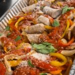 a baking dish full with the baked italian sausage you'll going to learn with this recipe