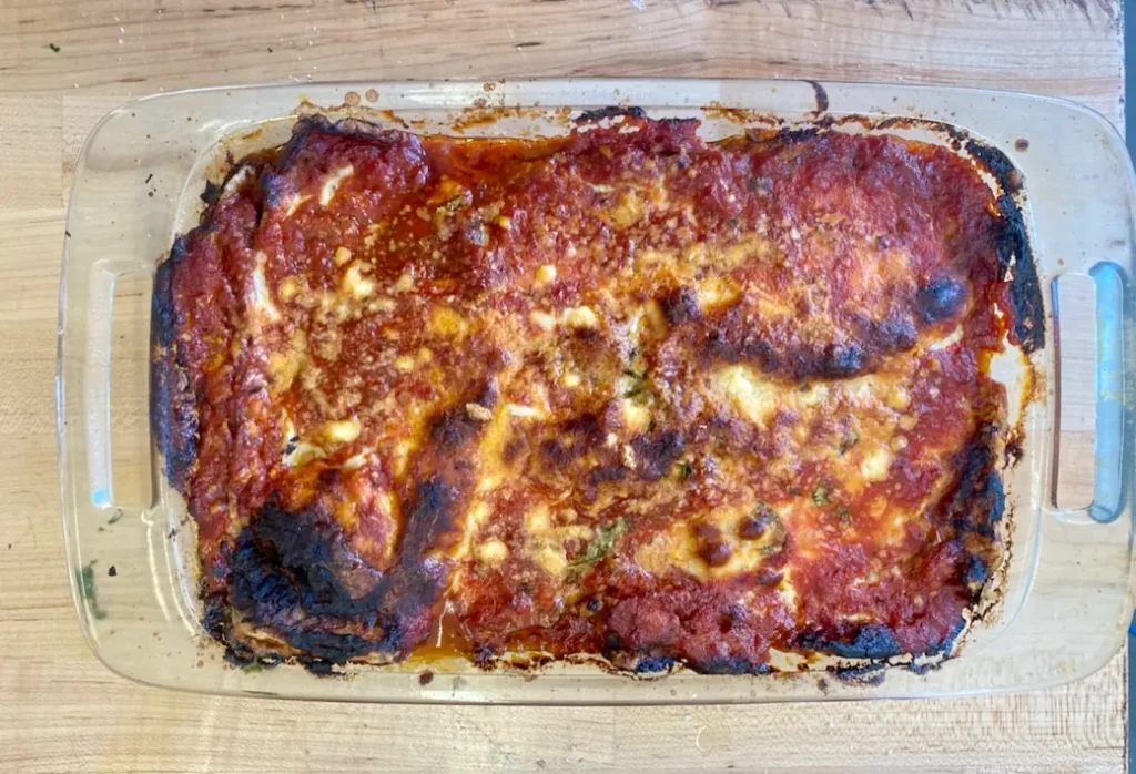 a hot tray full with eggplant parm made using our jarred tomato sauce