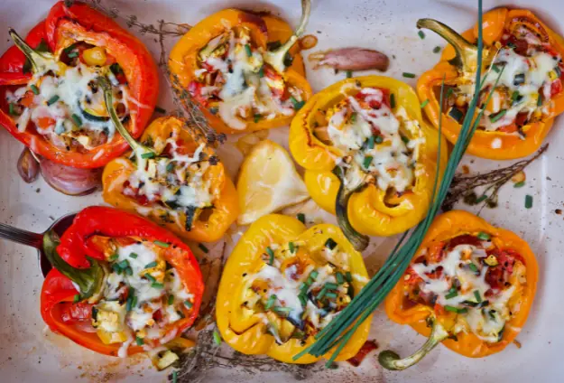 bell peppers of different colors stuffed with ratatouille