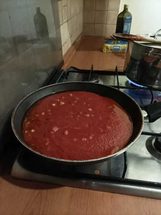 tomato sauce simmering with pancetta