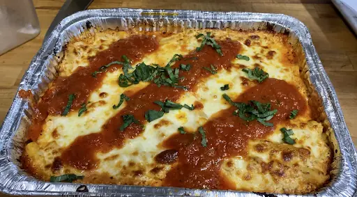 baked ziti topped with meat sauce and bechamel