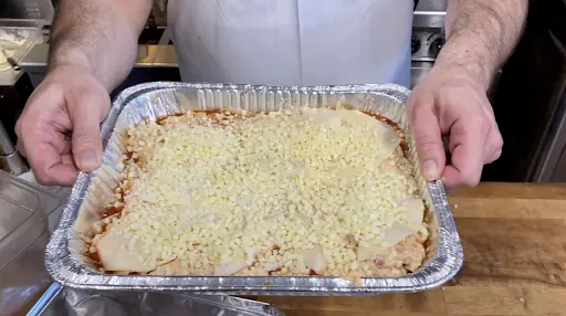 a casserole dish with a layered pasta dish that could be either baked ziti or lasagna